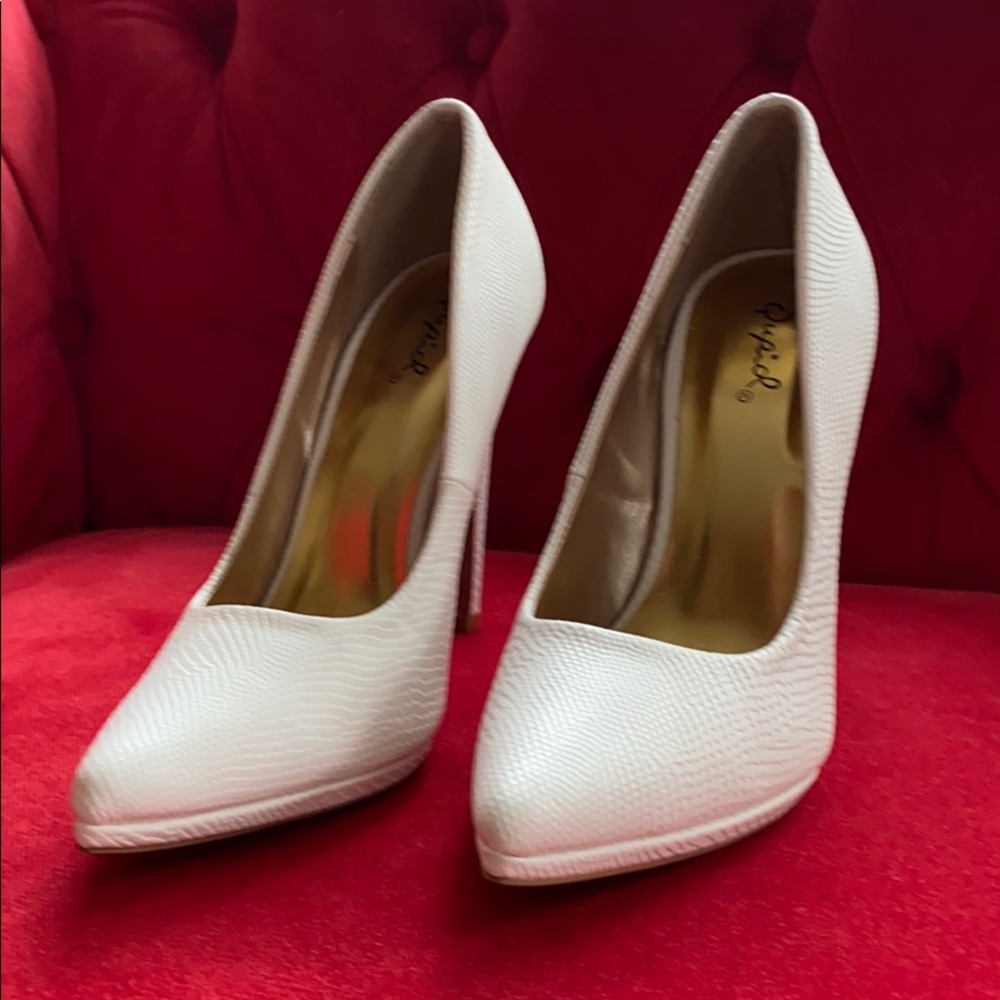Heels with a white snake skin look.